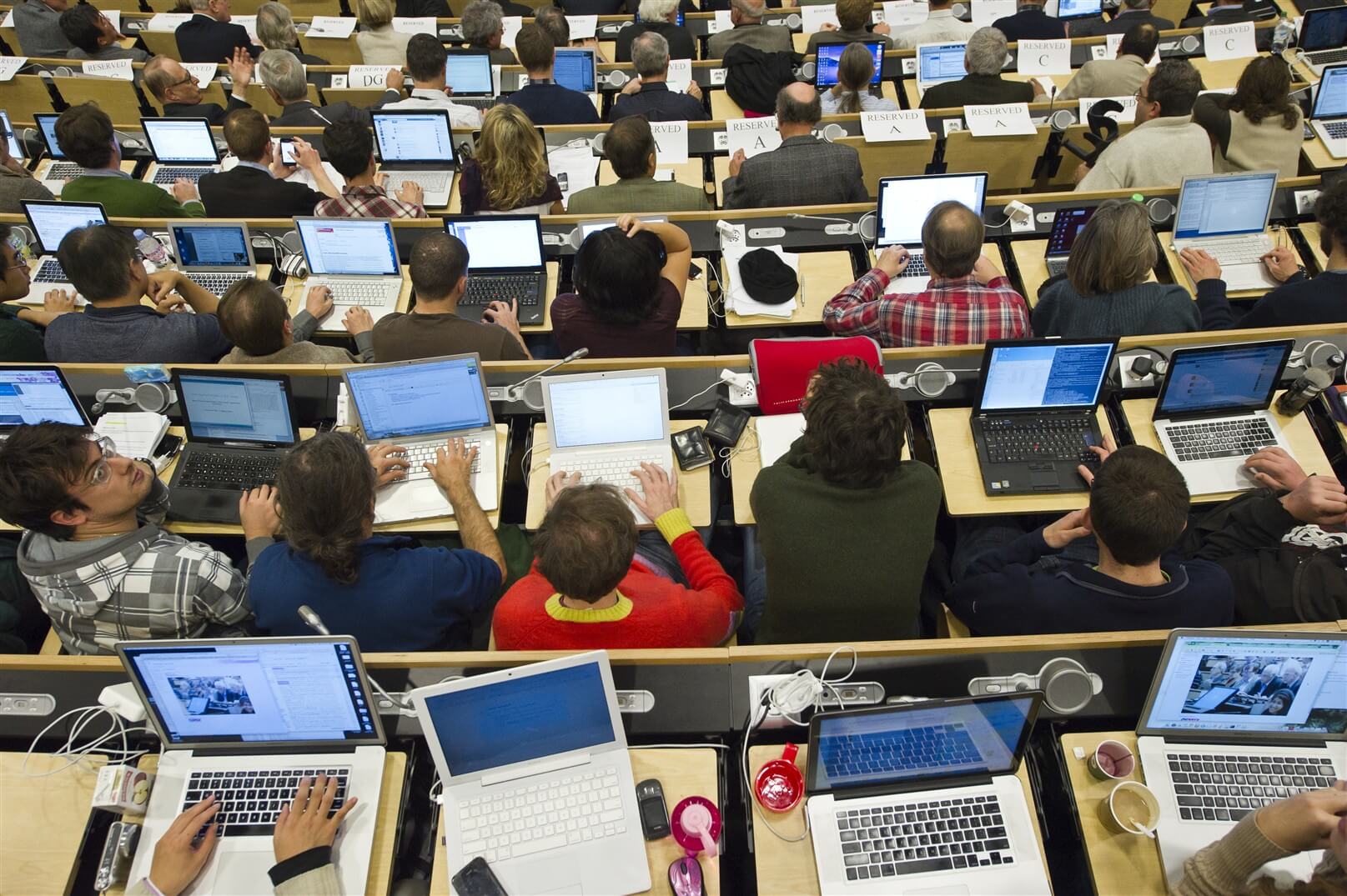 A diverse group of people seated, using their laptops. This signifies NORDUnet Global Collaborations