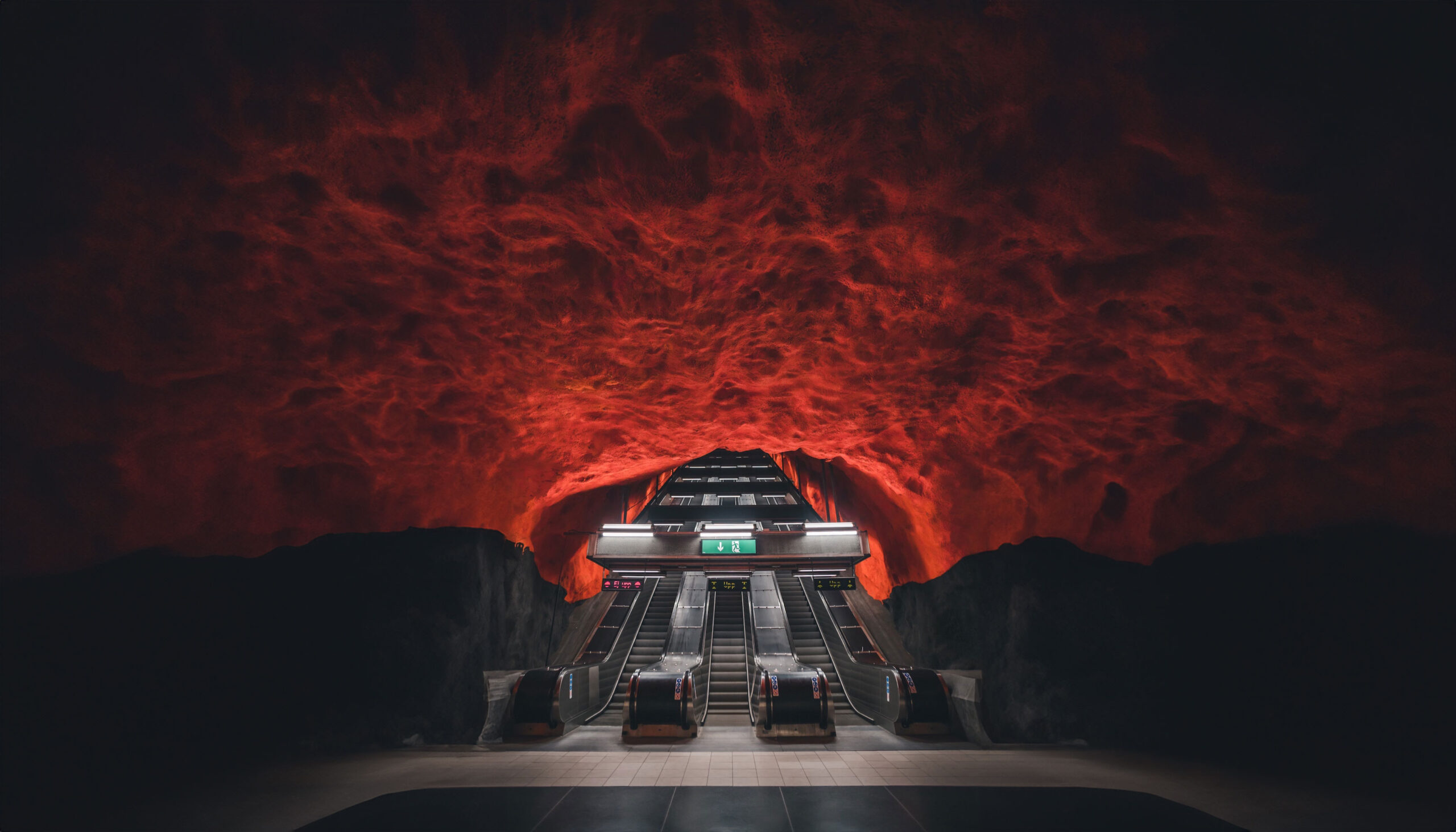 Dramatic underground metro station in Sweden with red cavernous ceiling, representing the innovative infrastructure supported by NORDUnet and Sweden's NREN.